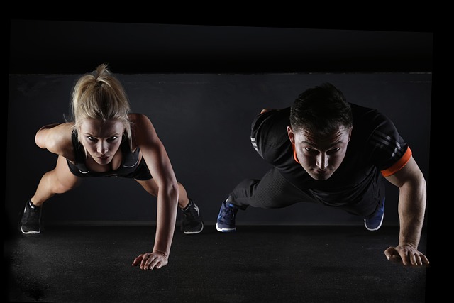 older couple doing light resistance band exercises at home smiling